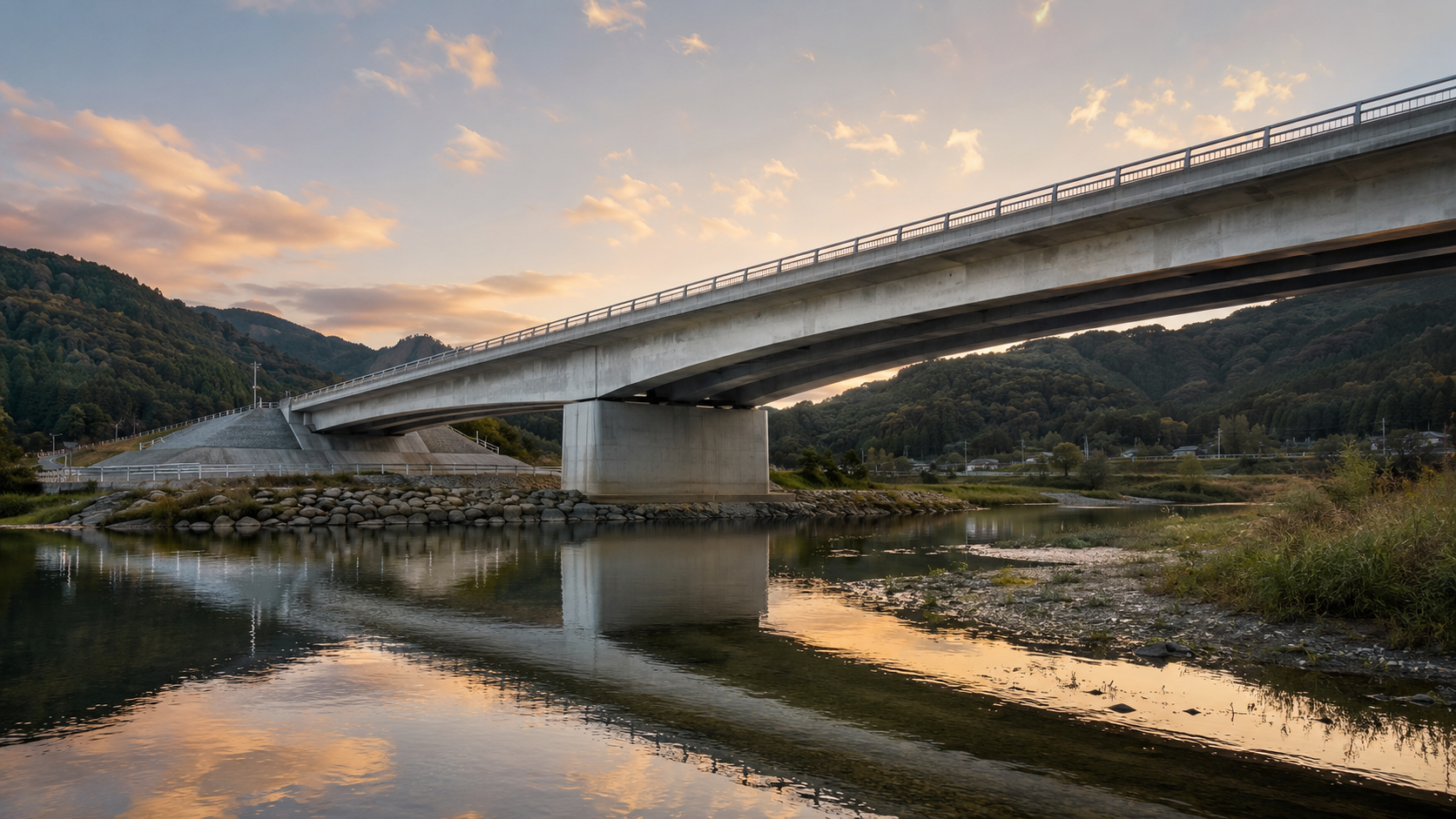 夕景に浮かび上がる完成した橋と川